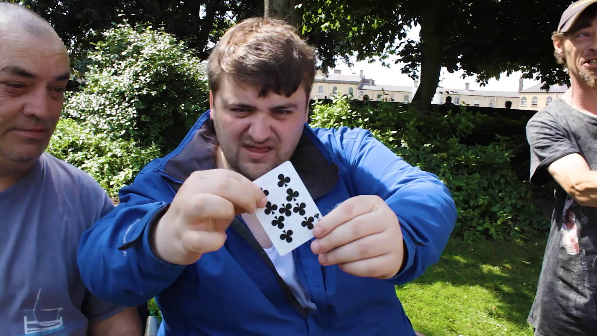 Man holding a playing card as part of card trick