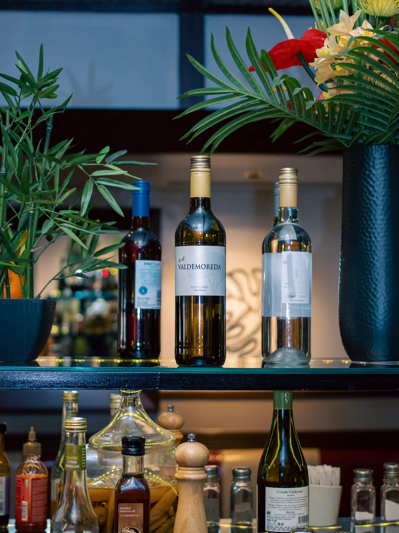 Bottle of wine on glass display shelf in a restaurant