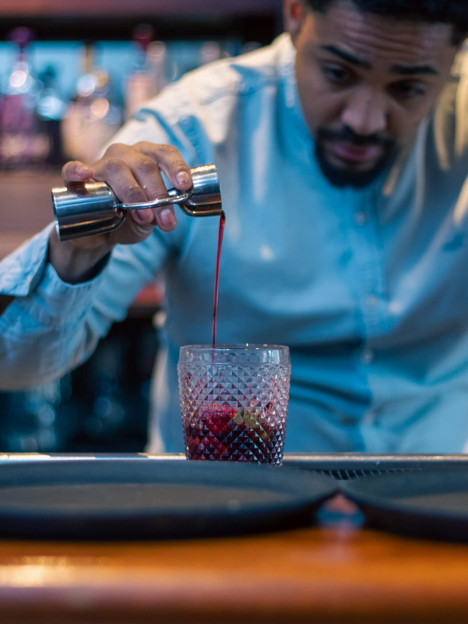 Bartender preparing a fruity cocktail